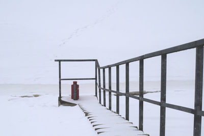 Man in snow against sky during winter