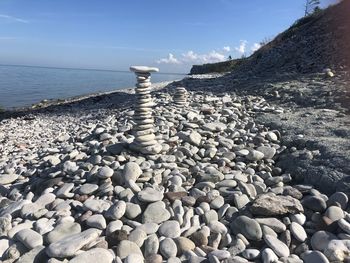 Surface level of stones on beach against sky