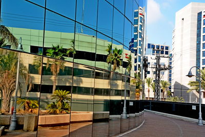 Street by buildings against sky