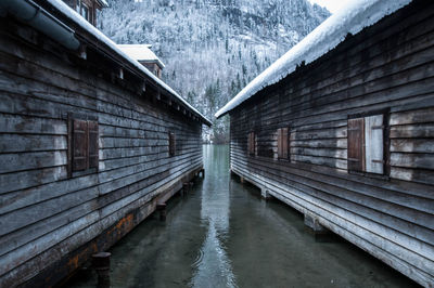 Bridge over canal amidst buildings during winter