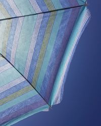 Low angle view of rainbow against clear blue sky