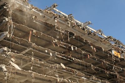 Low angle view of abandoned building against sky