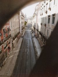 Street amidst buildings in city against sky