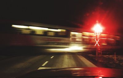 Light trails on road against sky at night