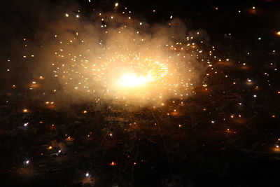 Low angle view of firework display at night