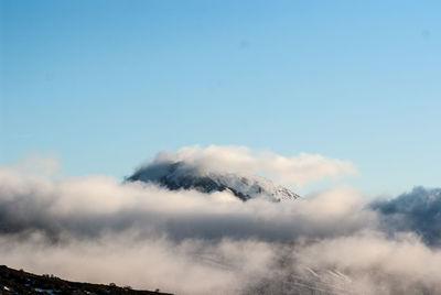 Low angle view of clouds over mountain