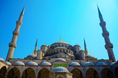 Low angle view of building against clear blue sky