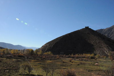 Scenic view of mountains against clear blue sky