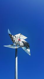 Low angle view of flags against blue sky