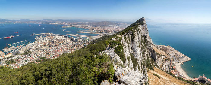 Panoramic view of sea and cityscape against sky