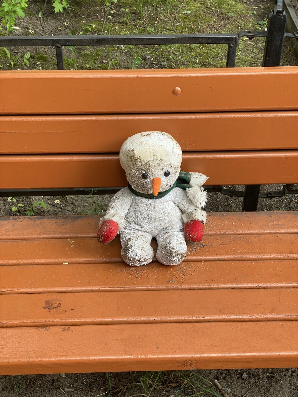 CLOSE-UP OF TOY ON BENCH AT PARK