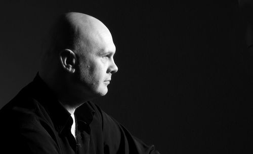 Close-up of a man over black background