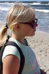 Portrait of boy wearing sunglasses on beach