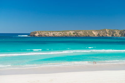 Scenic view of sea against clear blue sky