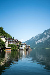 Scenic view of buildings and mountains against clear sky