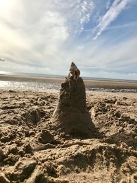 Scenic view of rocks on beach against sky