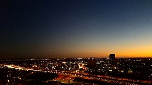 High angle view of city lit up at night