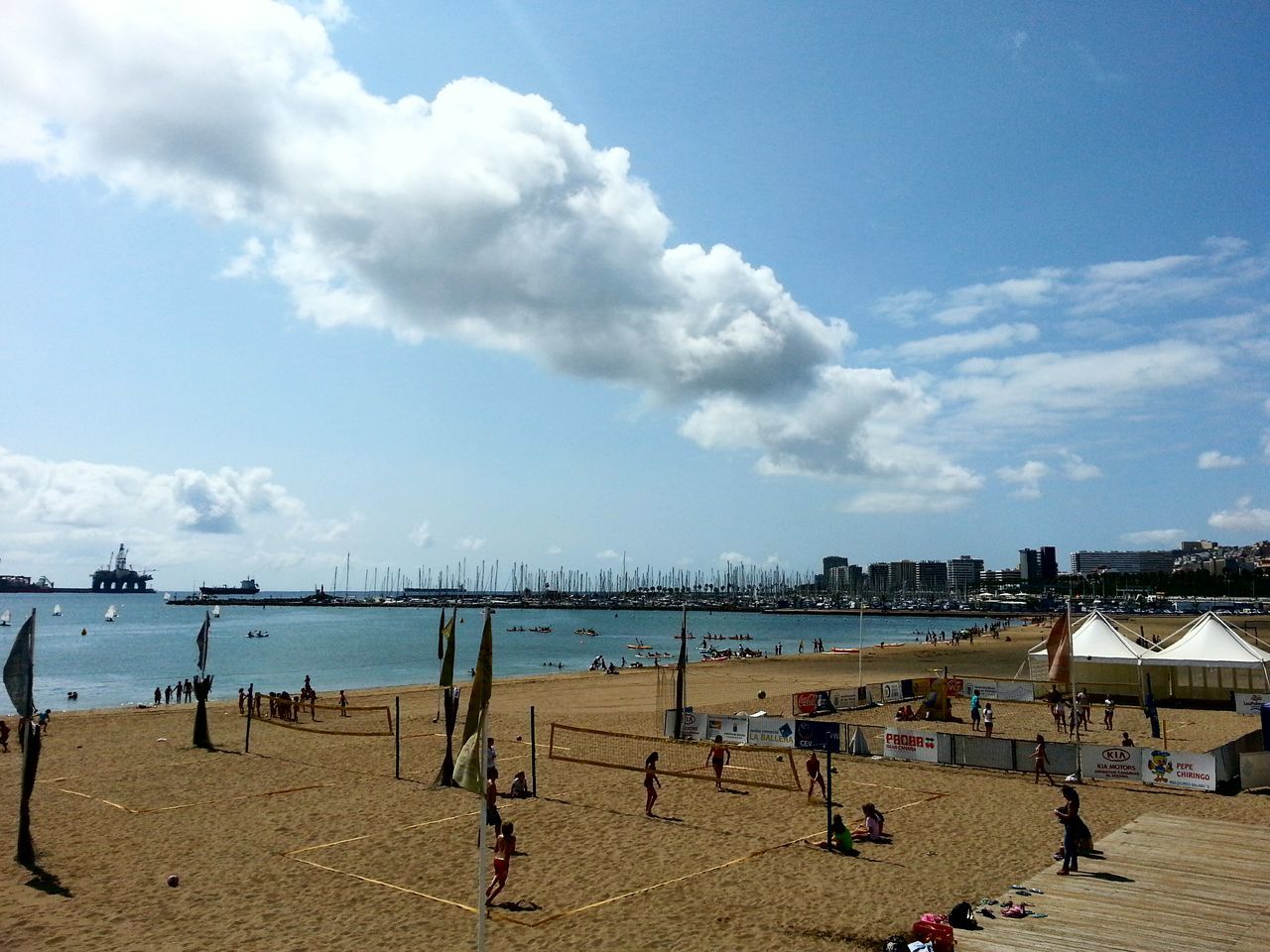 beach, sea, water, sky, sand, shore, large group of people, vacations, cloud - sky, leisure activity, lifestyles, person, cloud, men, horizon over water, built structure, tourism, tourist, day