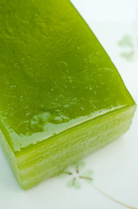 Close-up of green leaf on table