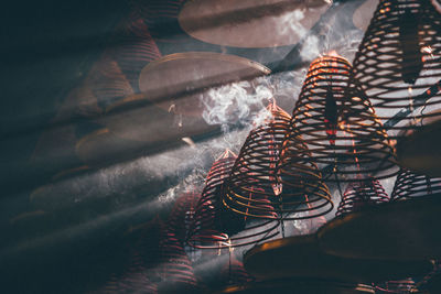 Low angle view of spiral incenses in temple