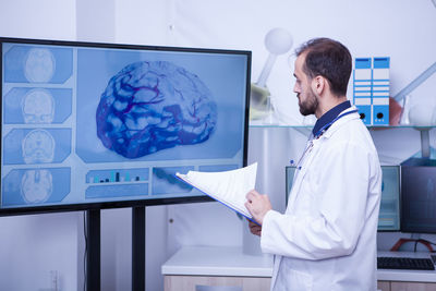 Side view of businessman using digital tablet in office