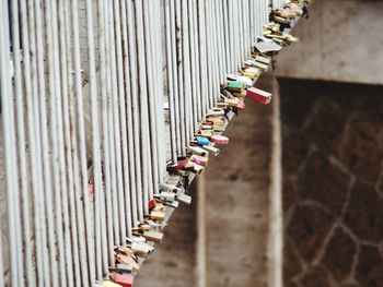 Low angle view of padlocks hanging on fence