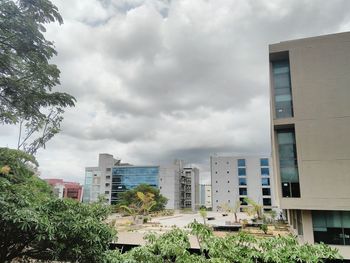 Buildings against cloudy sky