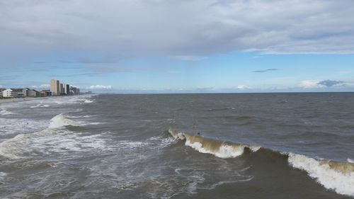 Scenic view of sea against cloudy sky