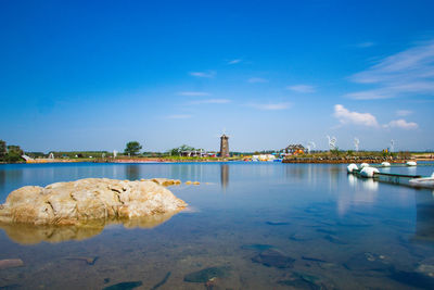 Scenic view of sea against blue sky