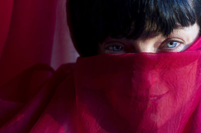 Close-up portrait of boy with red eyes