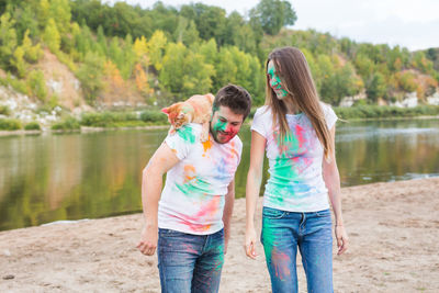 Rear view of father and daughter in lake