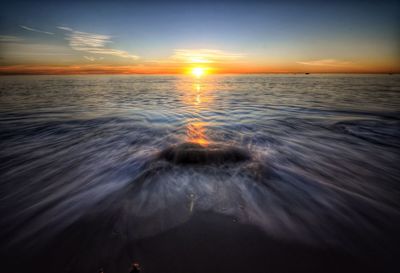 Scenic view of sea at sunset