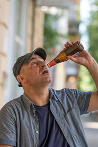 Man drinking beer straight from the bottle
