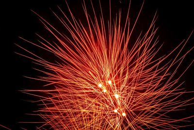 Low angle view of firework display at night