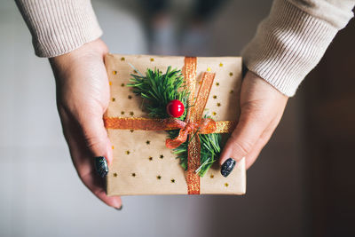 Low section of woman holding gift box