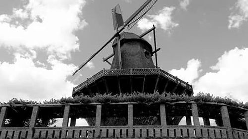 Low angle view of built structure against cloudy sky