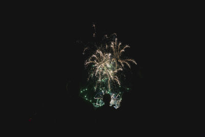 Low angle view of firework display at night