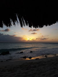 Scenic view of beach against sky during sunset