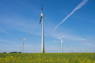 Windmill on field against sky
