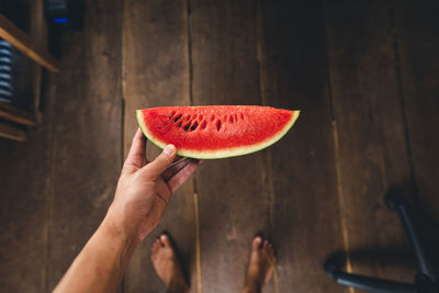 Midsection of person holding apple