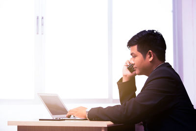 Businessman using laptop in office