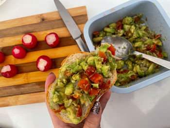 Cropped hand of person holding food