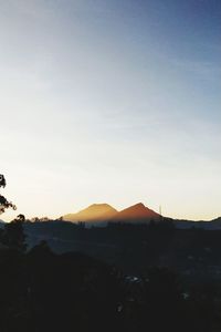 Scenic view of silhouette mountains against sky at sunset