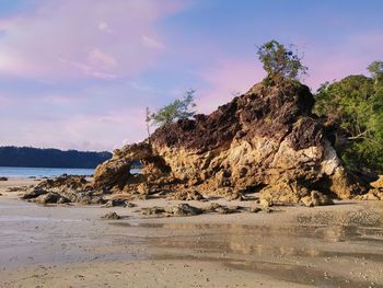 Rocks on beach against sky