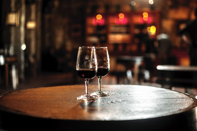 Close-up of alcoholic drinks served on wooden table in restaurant