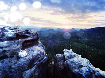 Rocks on mountain against sky during sunset