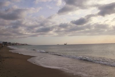 Scenic view of beach against sky during sunset