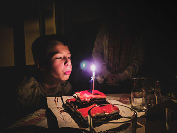 Young woman with cake on table