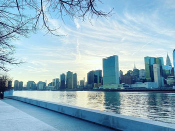 River amidst buildings in city against sky