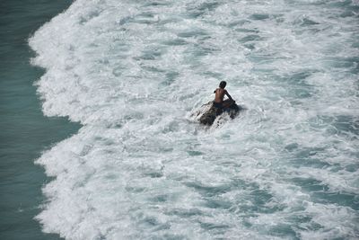 High angle view of man swimming in sea